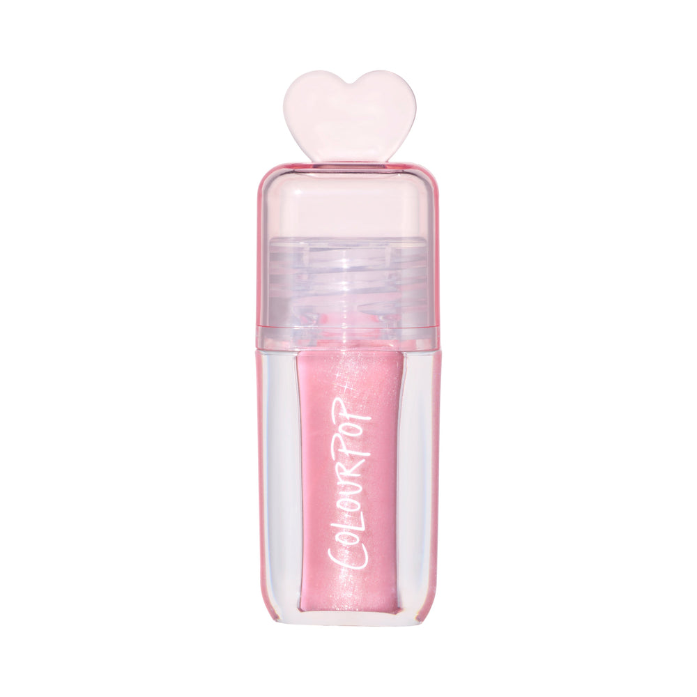 ColourPop 2 Die 4 Ultra Glossy Lip standing upright against a white background, showing its shimmery light pink Heart to Get shade in a clear pink tube topped with a translucent heart-shaped cap for cute, high-shine lip gloss looks.
