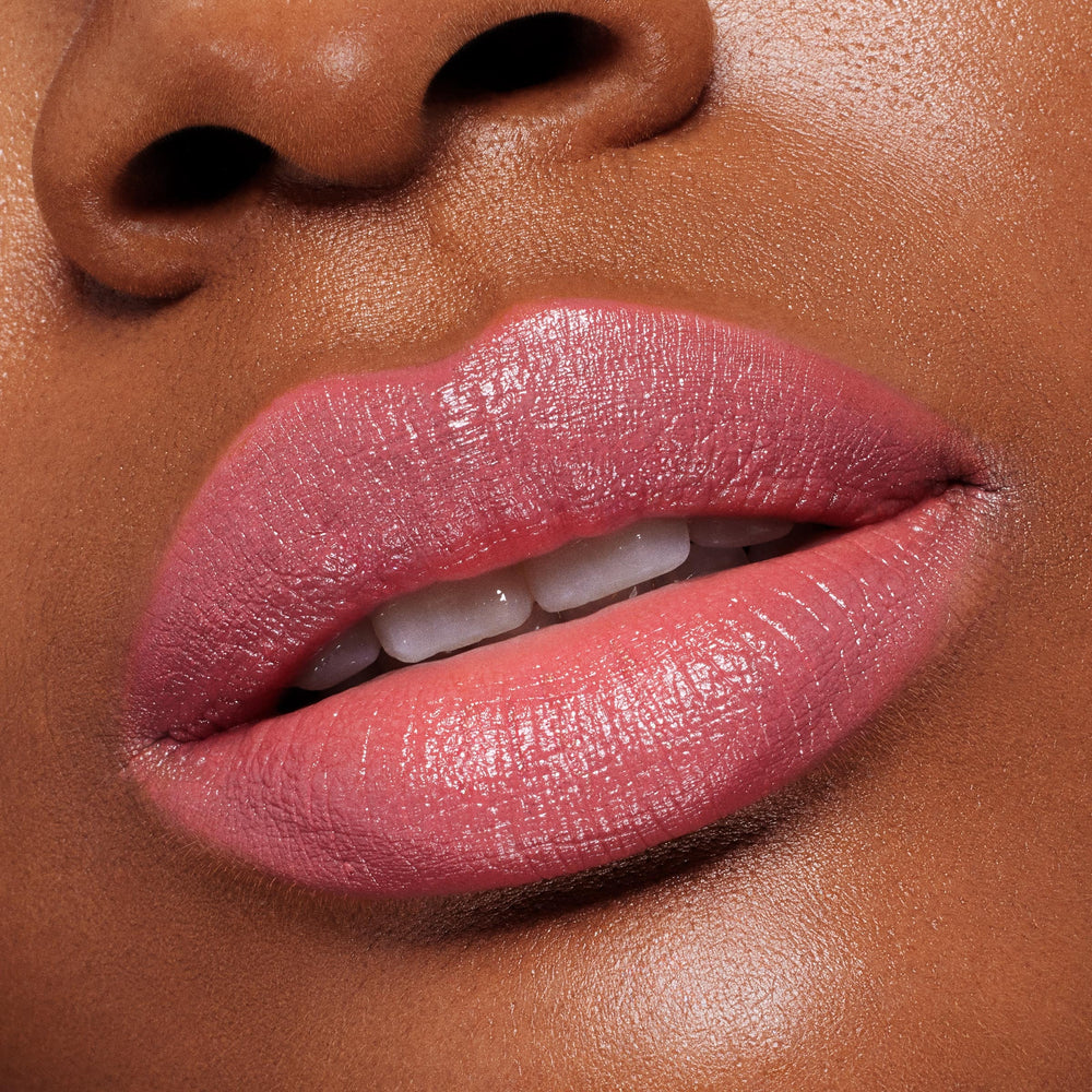 Lips wearing ColourPop Lippie Stix in Felt Cute, a creamy soft pink, reflecting a glossy satin sheen; extreme close-up shows full, even coverage and smooth, hydrated texture for a natural everyday lip look.