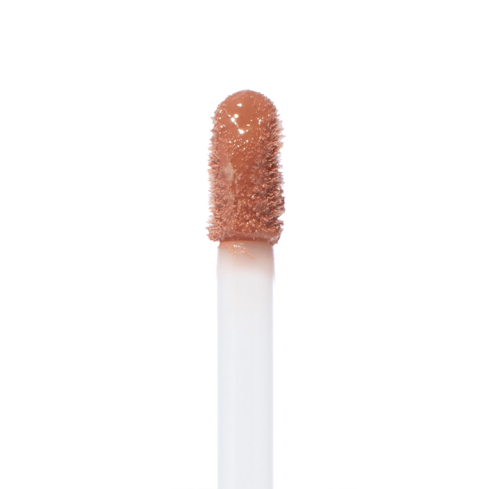 Doe-foot wand saturated with Starling Ultra Blotted Lip in a peachy nude, standing upright against a white background; ColourPop Ultra Blotted Lip applicator shown in macro, highlighting the velvety, blotted texture.